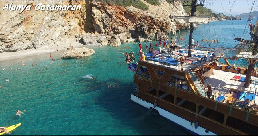 Alanya: Catamaran Boat Trip with Sunbathing and Swimming - Leaving the harbor beside the Red Tower